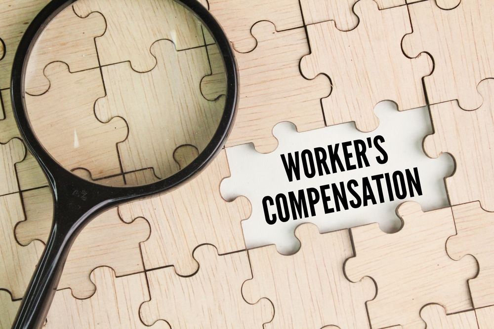 Magnifying,Glass,And,Wooden,Puzzle,With,The,Word,Workers',Compensation.