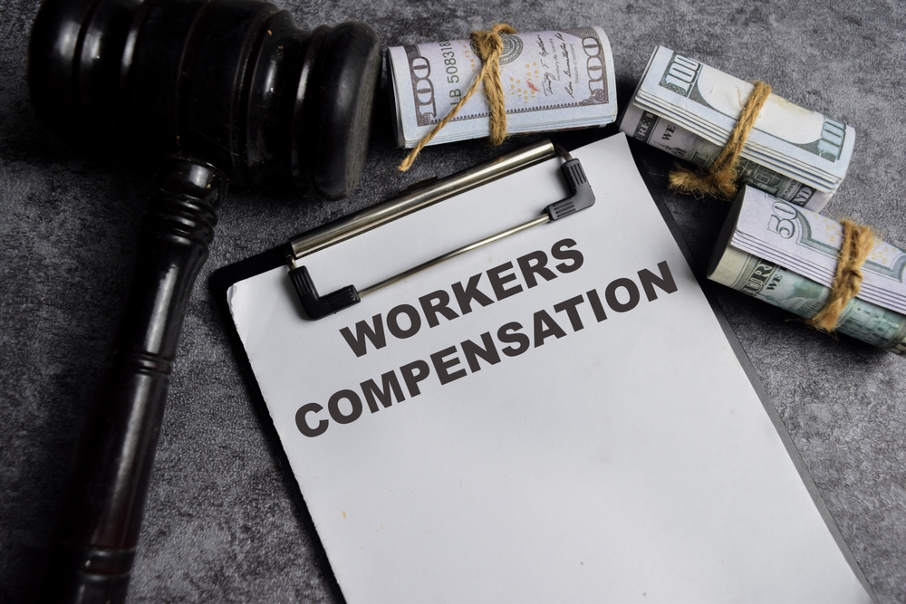 Concept,Of,Workers,Compensation,Write,On,Paperwork,Isolated,On,Wooden